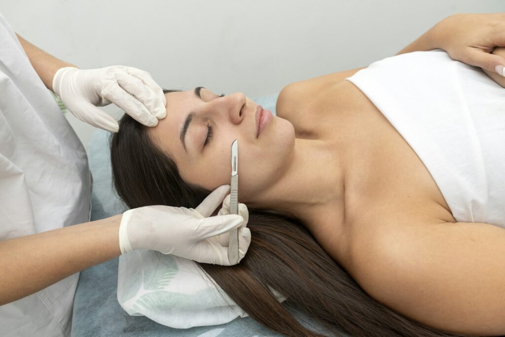 Hispanic female patient with eyes closed in the cosmetic clinic preparing for dermaplaning treatment